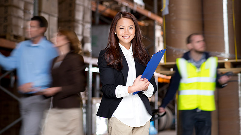 Lady holding file in a warehouse