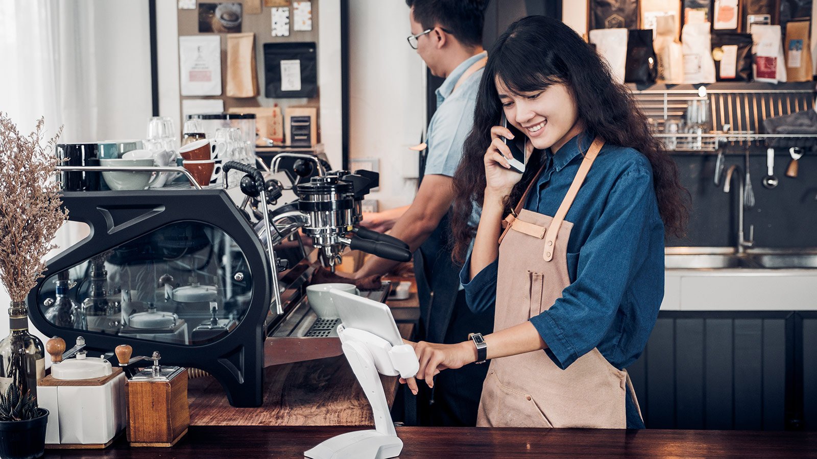 Cashier making entry on pos machine