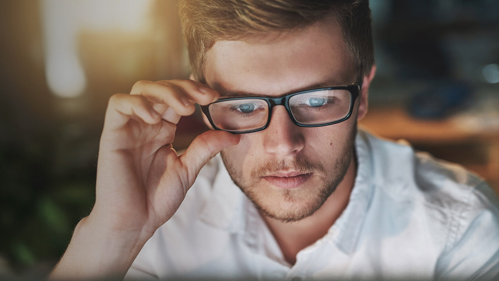 Man with spectacles using notebook