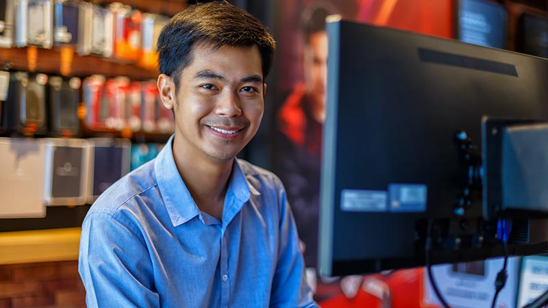 Handsome young asian man using computer in office