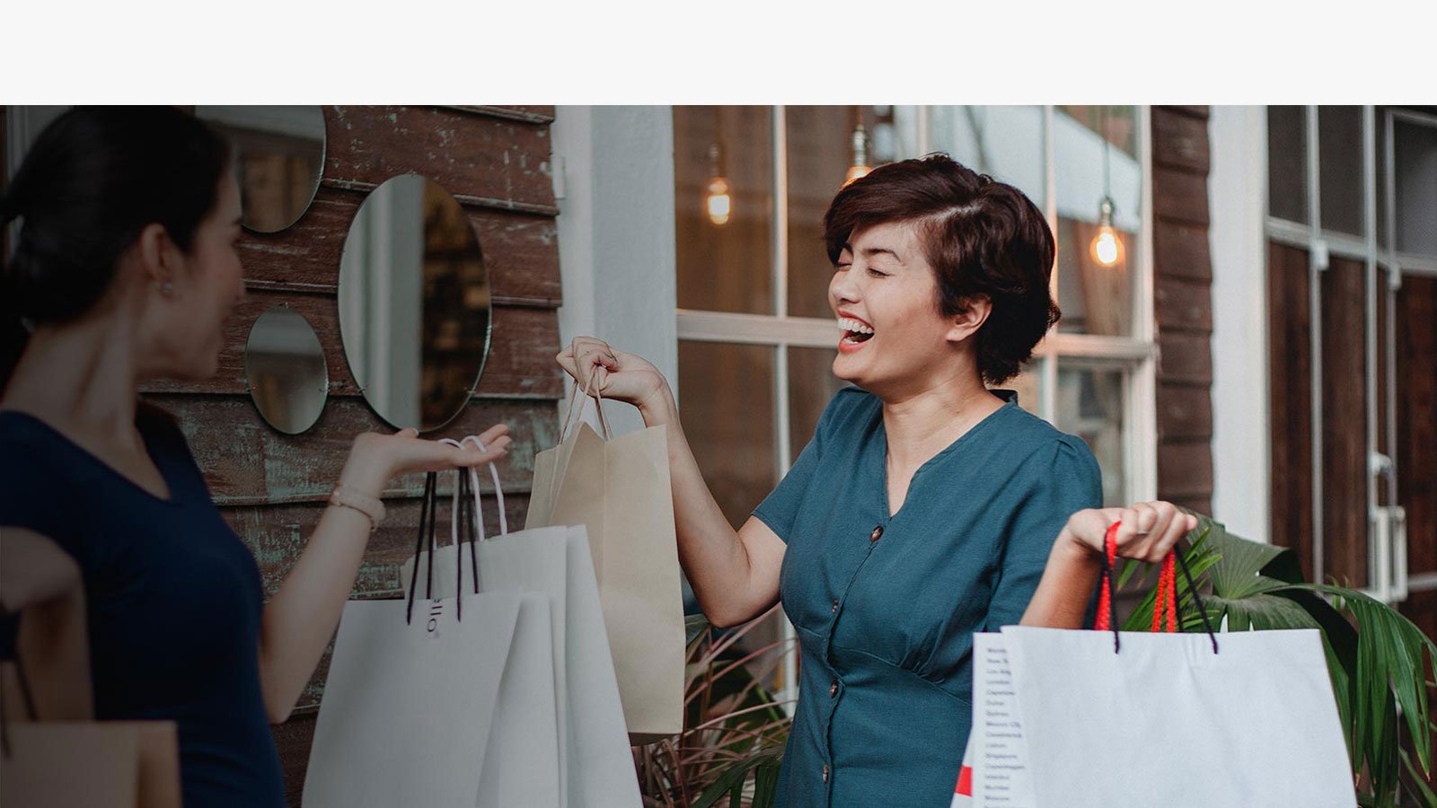 Ladies showing their shopping bags