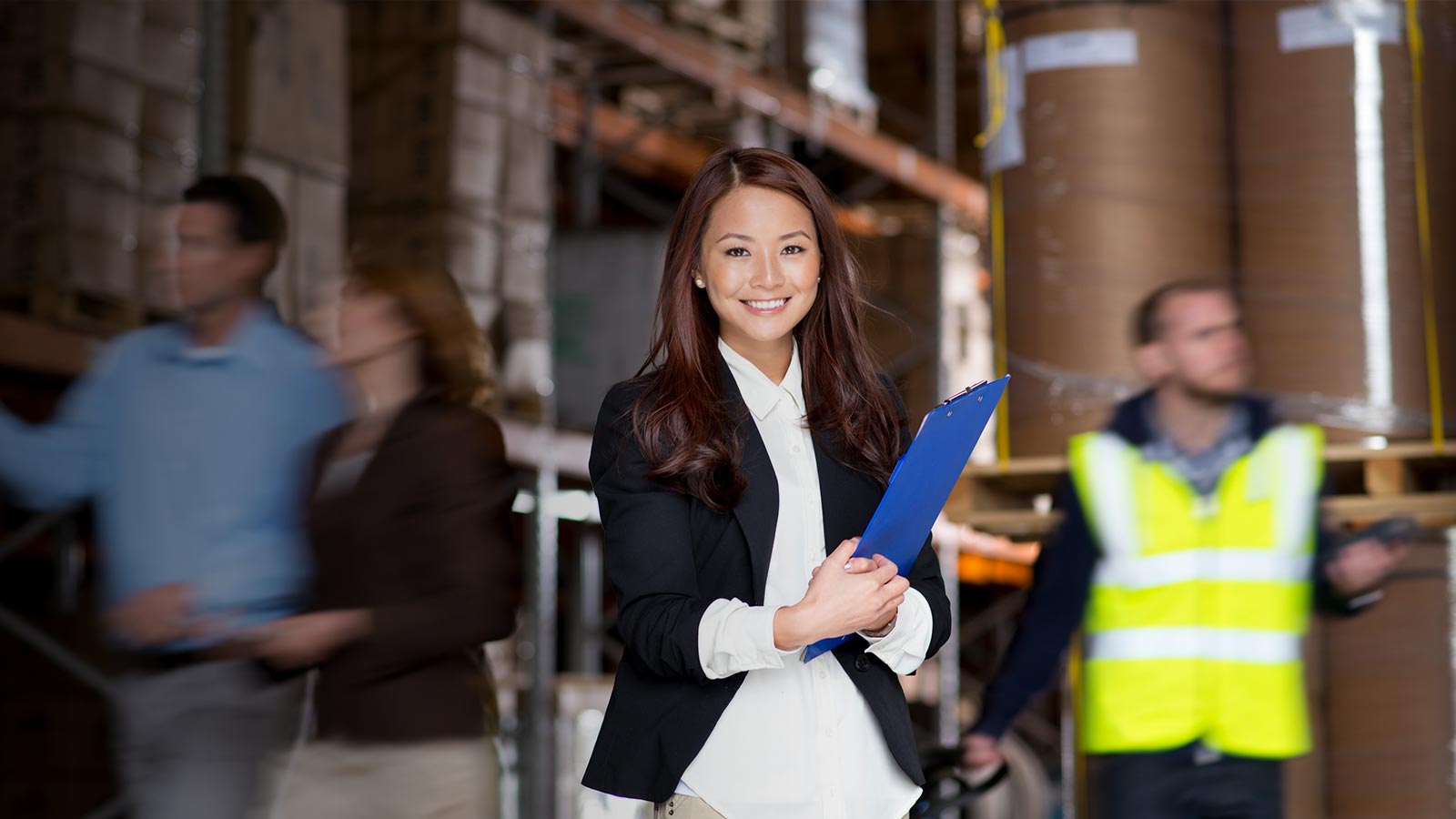 a lady holding a file in a factory